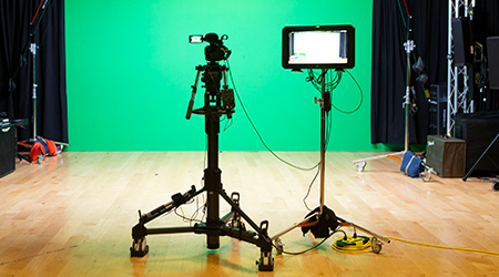 A HD camera and lights in the Informatics video studio