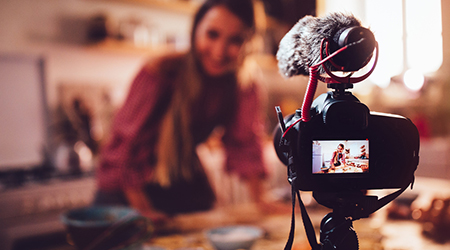 A photo of a woman filming herself