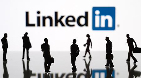 Business people walking below LinkedIn logo