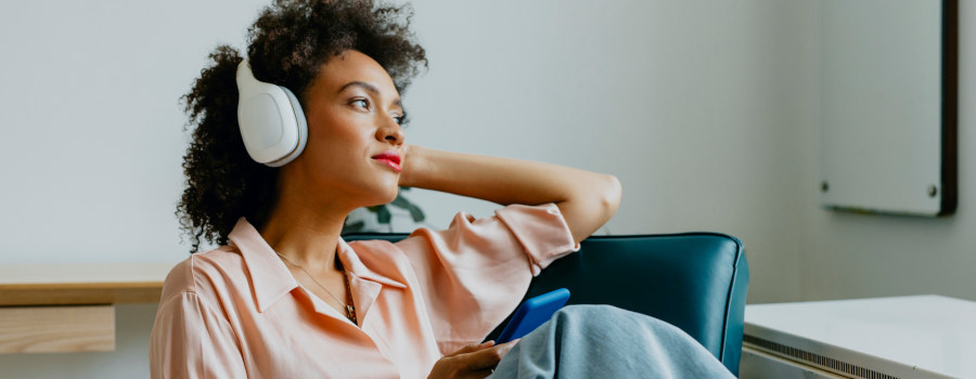 Woman listening to podcast advertising on headphones